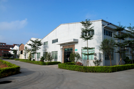 Factory office with our red multi-story dormitory in the back ground